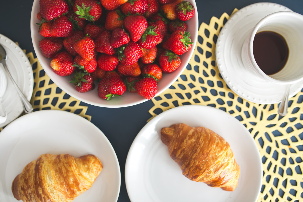kaboompics.com_Fresh buttery croissants, hot cup of coffee and bowl with strawberries